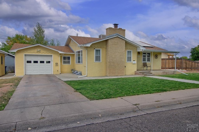 ranch-style home featuring a chimney, an attached garage, a front yard, fence, and driveway