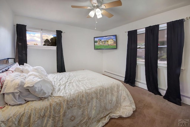 carpeted bedroom with a ceiling fan and a baseboard radiator