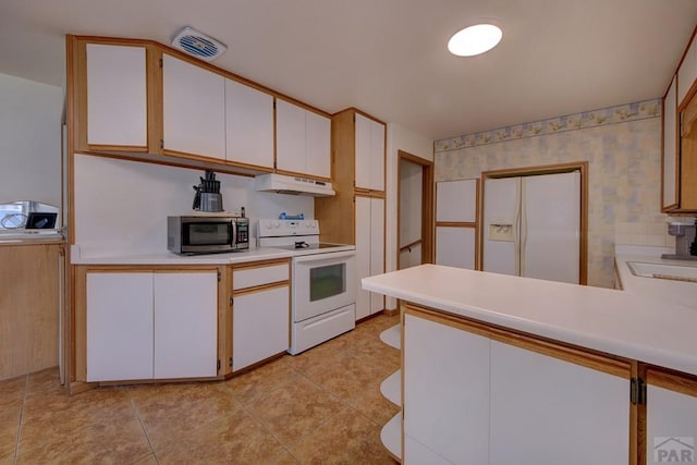 kitchen featuring white electric range oven, stainless steel microwave, light countertops, under cabinet range hood, and white cabinetry