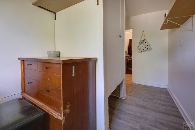 hall with light wood finished floors and baseboards