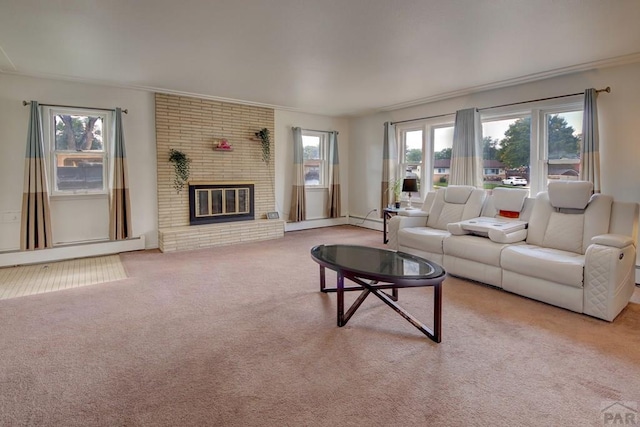 carpeted living room featuring a brick fireplace, a baseboard radiator, and a wealth of natural light