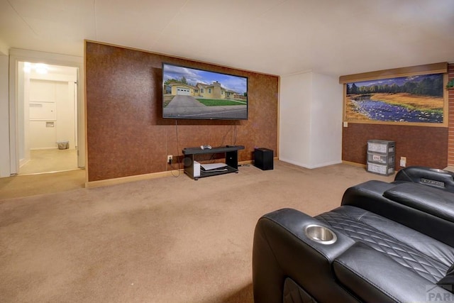 cinema room featuring light carpet and baseboards