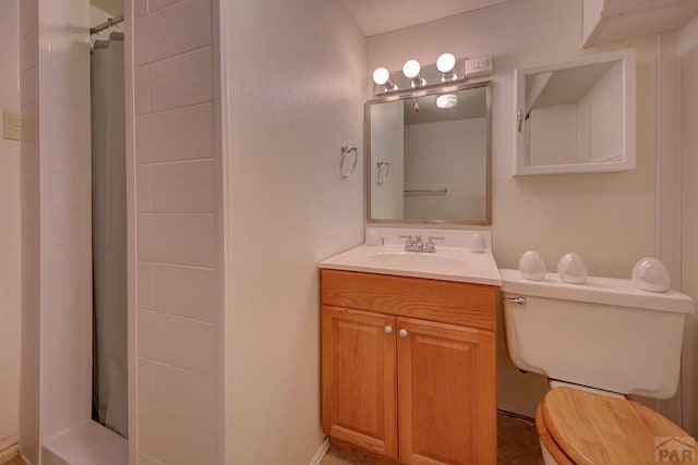 bathroom featuring toilet, curtained shower, and vanity