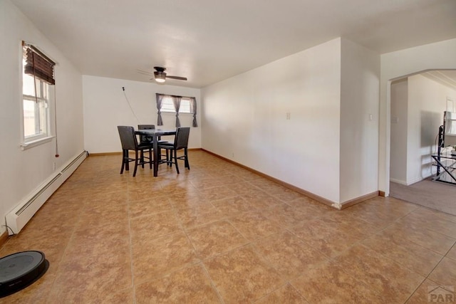 dining area featuring a wealth of natural light, a baseboard radiator, ceiling fan, and baseboards