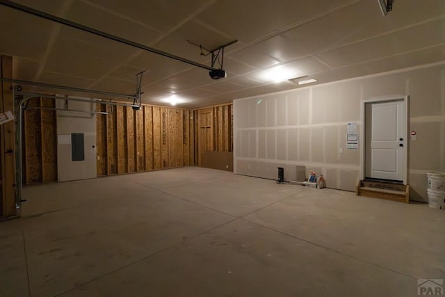 garage featuring electric panel and a garage door opener