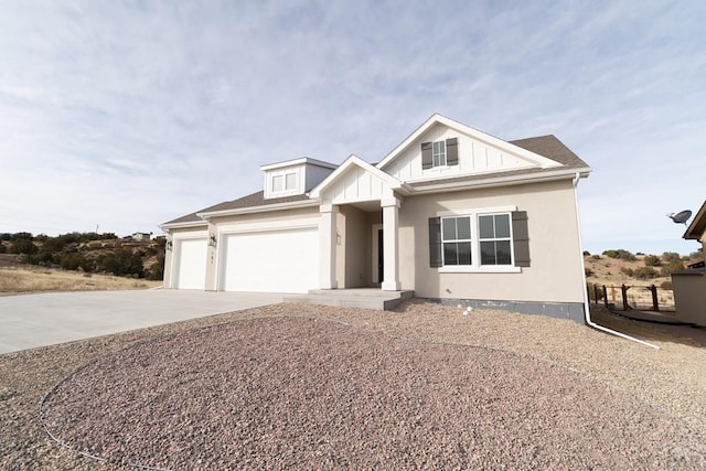 view of front of property featuring a garage, concrete driveway, board and batten siding, and roof with shingles