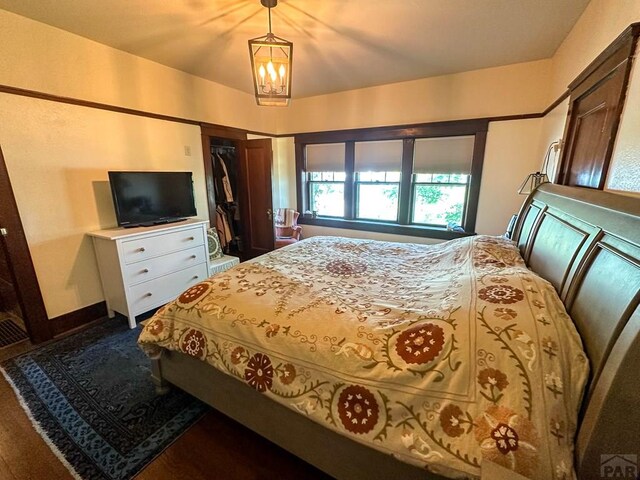 bedroom with a chandelier, a closet, and baseboards