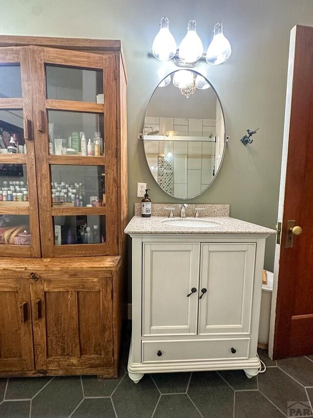 bathroom featuring an enclosed shower, vanity, and tile patterned floors