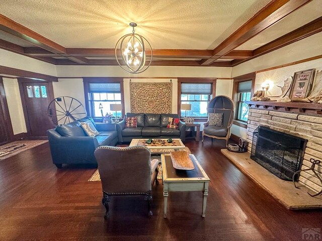 living room with a stone fireplace, coffered ceiling, beamed ceiling, and a textured ceiling