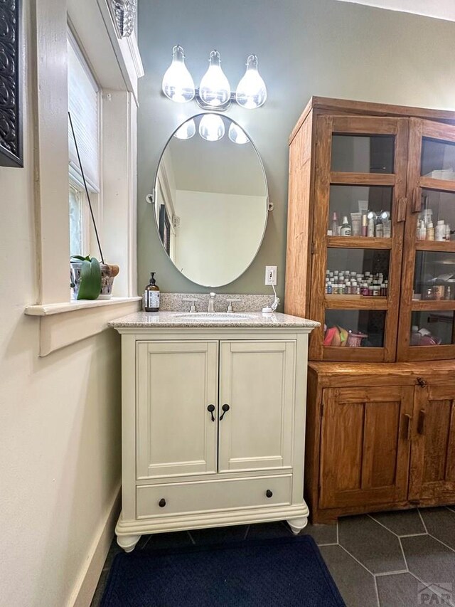 bathroom with tile patterned flooring and vanity