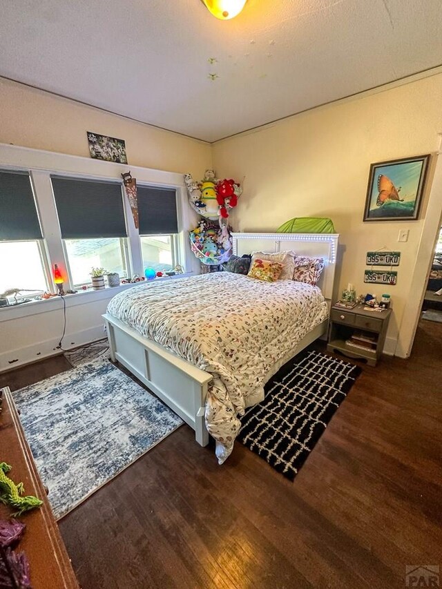 bedroom featuring dark wood finished floors