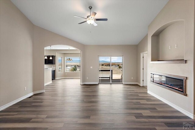 unfurnished dining area with a notable chandelier, light wood finished floors, plenty of natural light, and baseboards