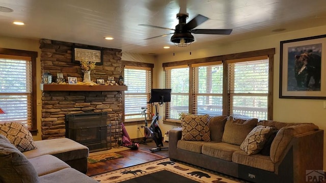 living room featuring ceiling fan, a fireplace, wood finished floors, and recessed lighting