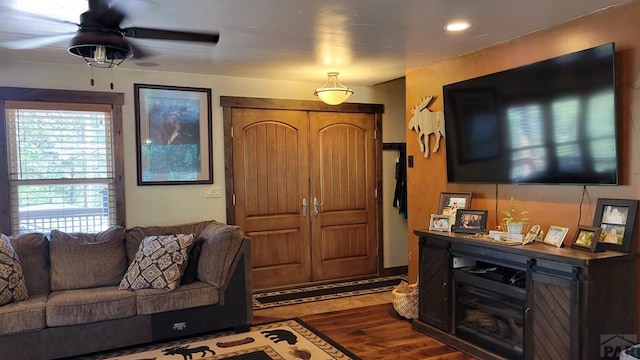 living area featuring ceiling fan and wood finished floors