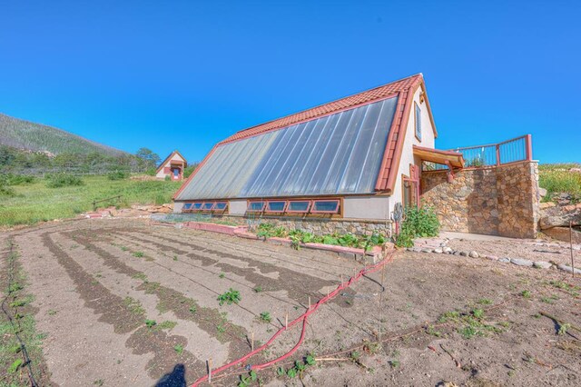 850 Rilling Canyon Rd, La Veta, CO 81055 - view of property exterior with metal roof, a gambrel roof, and stucco siding