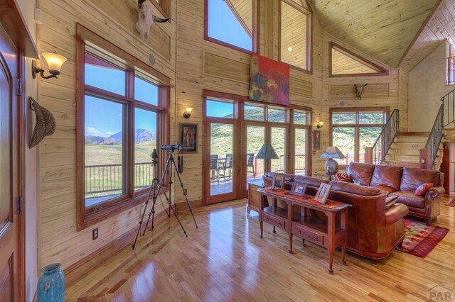 850 Rilling Canyon Rd, La Veta, CO 81055 - living area with high vaulted ceiling, wood walls, wood finished floors, french doors, and stairs