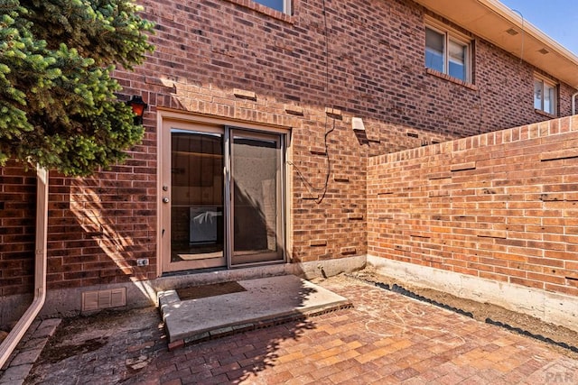 property entrance with brick siding