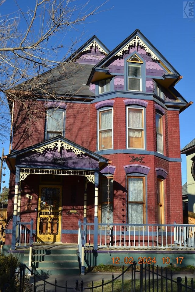 view of front of property featuring a fenced front yard and brick siding