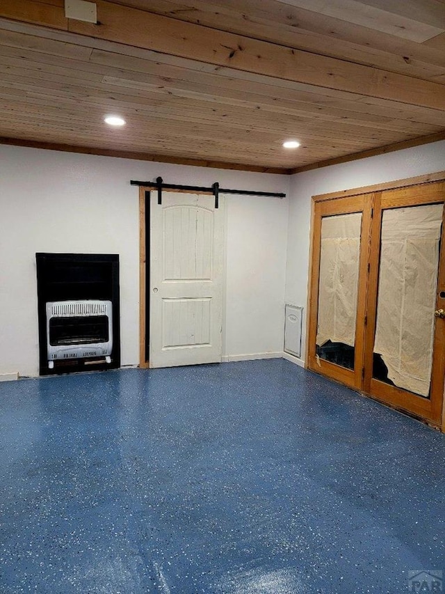 basement with wood ceiling, heating unit, recessed lighting, and a barn door