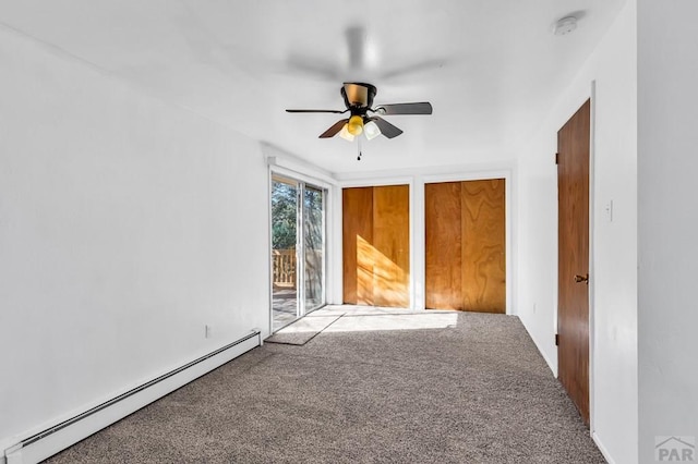 spare room with a ceiling fan, carpet flooring, and a baseboard radiator