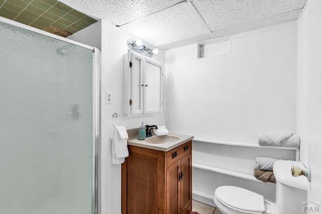full bath featuring toilet, a stall shower, and vanity