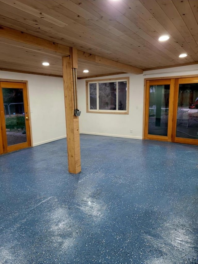 finished basement featuring wood ceiling, recessed lighting, and baseboards