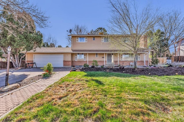 traditional home featuring a garage, fence, a front yard, and driveway