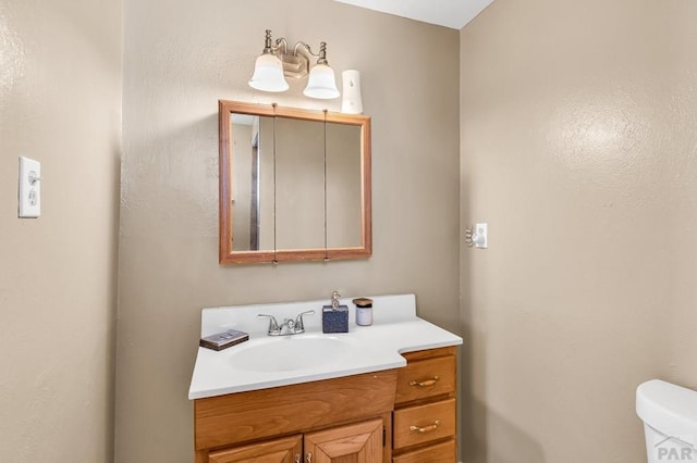 half bathroom with toilet and vanity