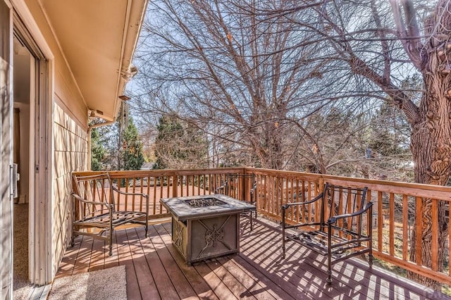 wooden deck with a fire pit
