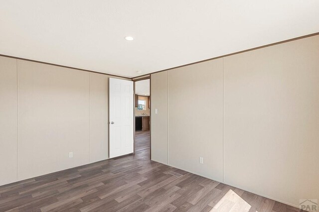 spare room featuring recessed lighting, ornamental molding, and wood finished floors