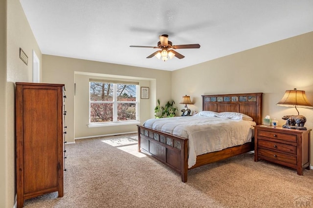 bedroom with light colored carpet, baseboards, and a ceiling fan