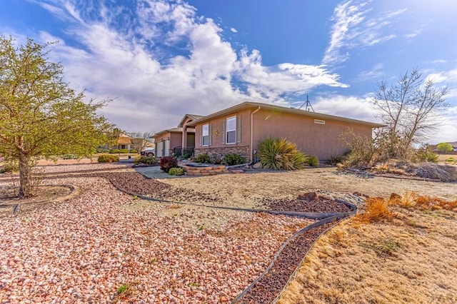 view of side of home with stucco siding and a garage