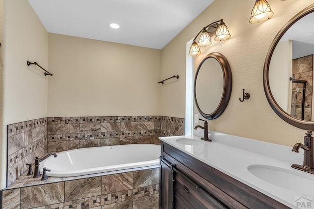 full bathroom with a bath, a sink, and double vanity