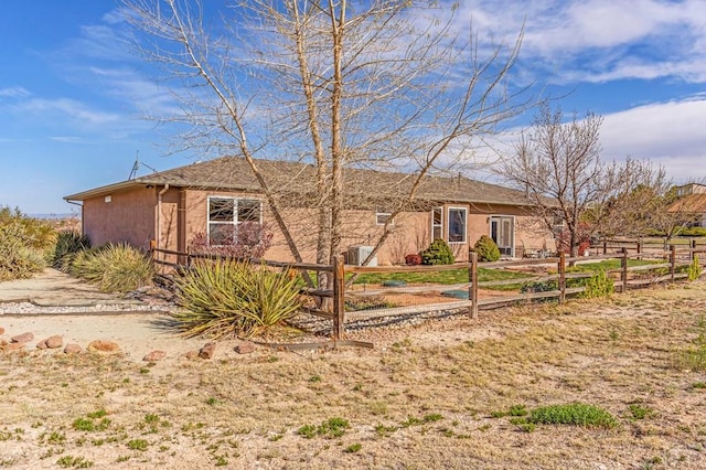 ranch-style home with fence