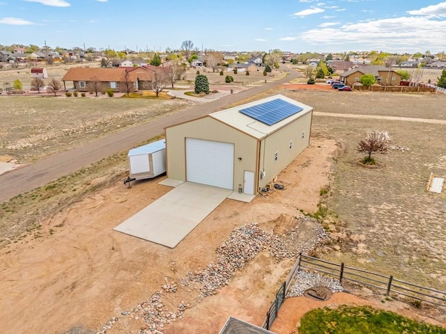 entry to storm shelter featuring fence, an outbuilding, and a residential view