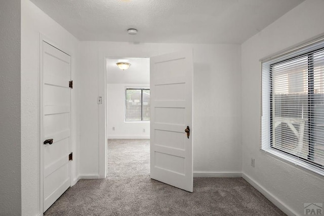 1638 Jackson St, Pueblo, CO 81004 - carpeted spare room with plenty of natural light, baseboards, a smoke detector, and a textured ceiling