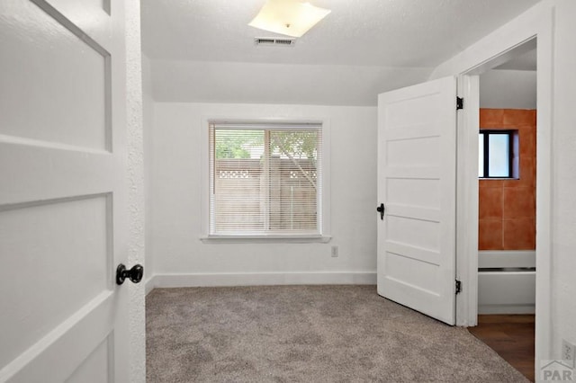 1638 Jackson St, Pueblo, CO 81004 - unfurnished bedroom featuring lofted ceiling and carpet