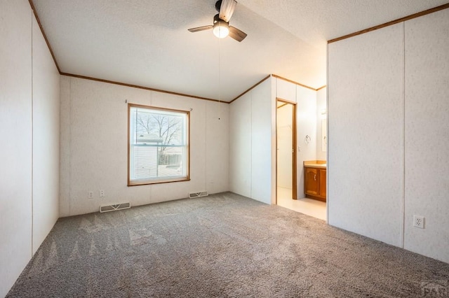 unfurnished bedroom with carpet, visible vents, connected bathroom, and ornamental molding