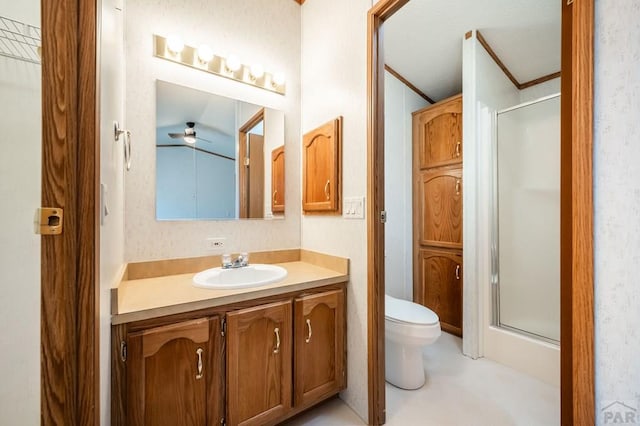 bathroom featuring toilet, a shower stall, crown molding, and vanity