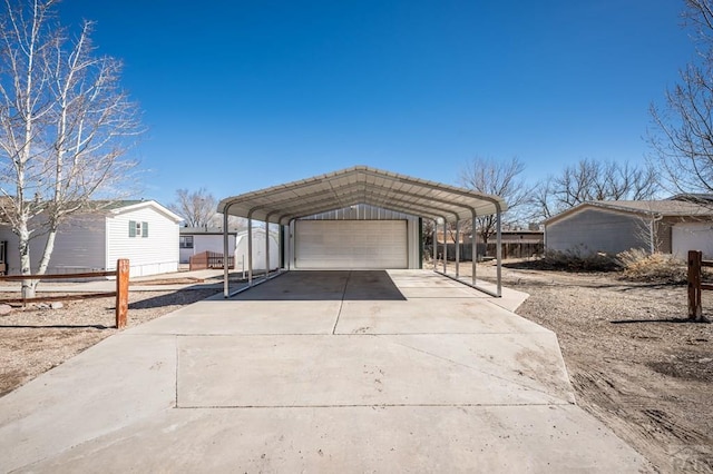 view of front of property featuring an outbuilding, a detached garage, and fence