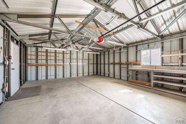 garage featuring a garage door opener and metal wall