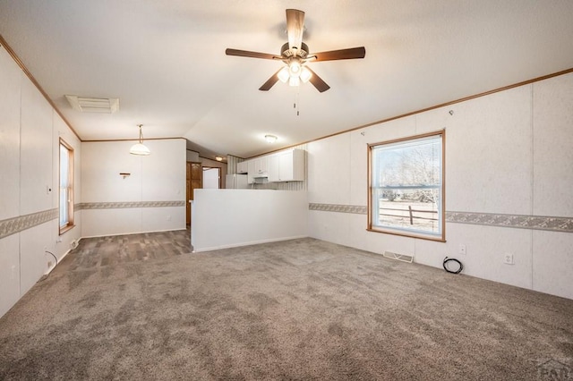 unfurnished living room with ornamental molding, lofted ceiling, visible vents, and carpet flooring