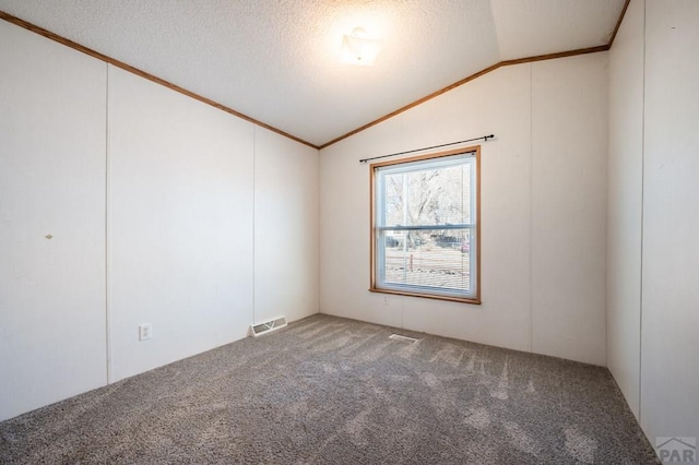 unfurnished room featuring carpet floors, crown molding, visible vents, vaulted ceiling, and a textured ceiling