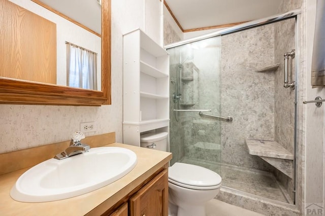 bathroom with a stall shower, vanity, and toilet