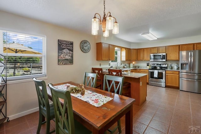 621 Twinflower Dr, Canon City, CO 81212 - tiled dining area featuring a chandelier and a textured ceiling