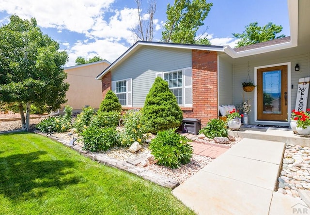 621 Twinflower Dr, Canon City, CO 81212 - view of front facade with brick siding and a front lawn