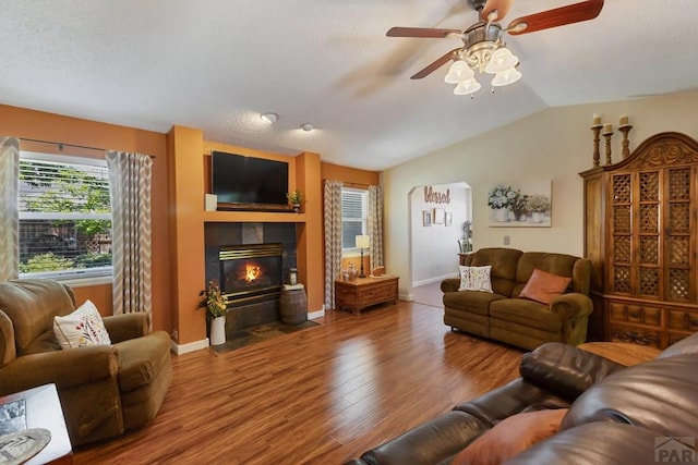 621 Twinflower Dr, Canon City, CO 81212 - living room featuring a ceiling fan, healthy amount of natural light, a tile fireplace, lofted ceiling, and wood finished floors