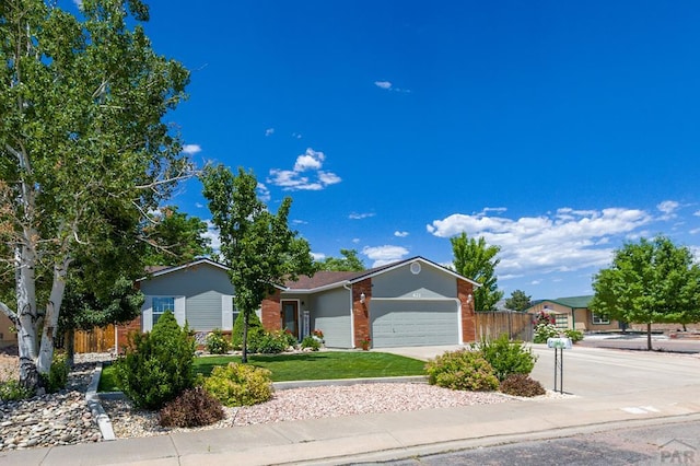 621 Twinflower Dr, Canon City, CO 81212 - single story home featuring brick siding, a garage, and driveway