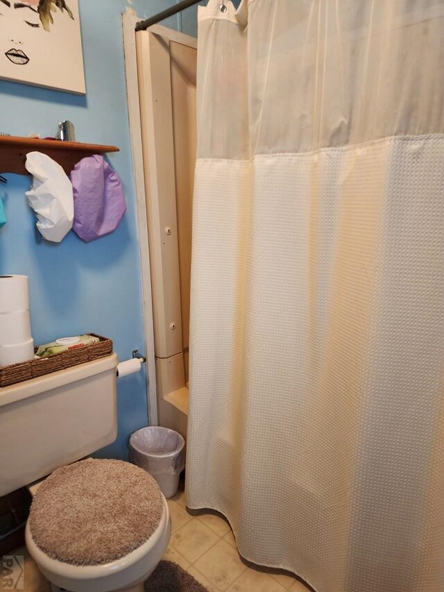 bathroom featuring tile patterned flooring and toilet