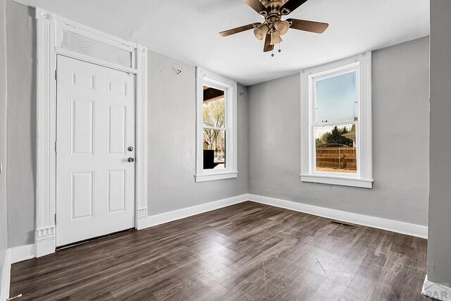 1111 Topaz Pl, Pueblo, CO 81004 - entrance foyer with baseboards, visible vents, dark wood-type flooring, and ceiling fan